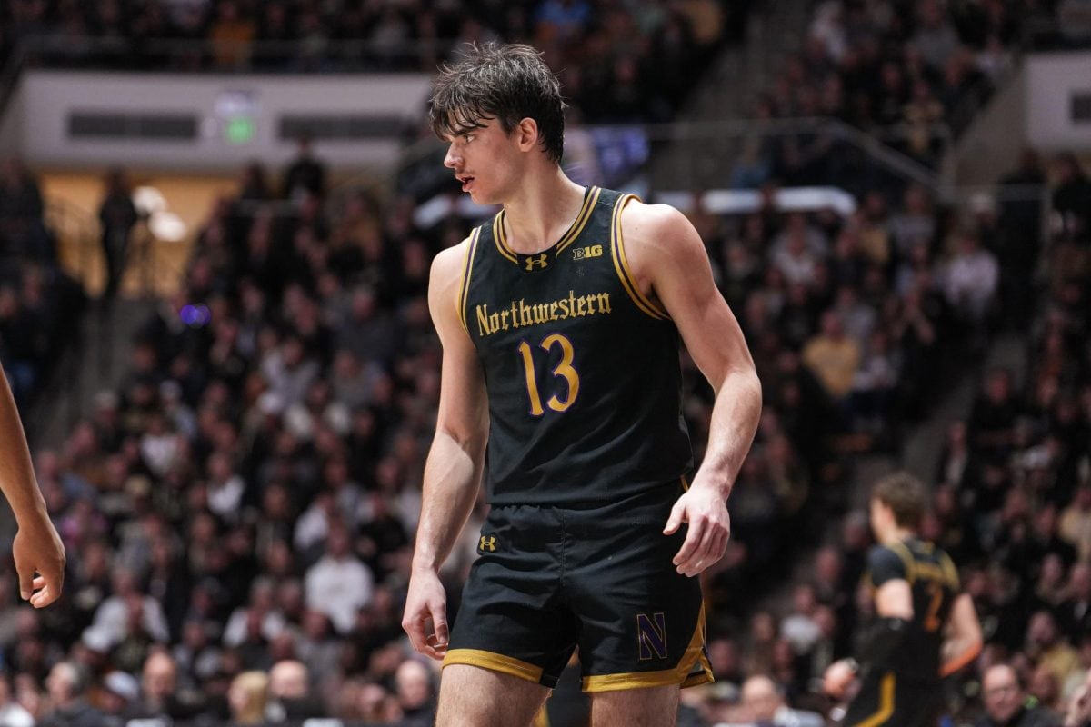 Senior guard Brooks Barnhizer, missing his two front teeth, stares down a defender against Purdue Sunday. Barnhizer scored 11 points in the loss.