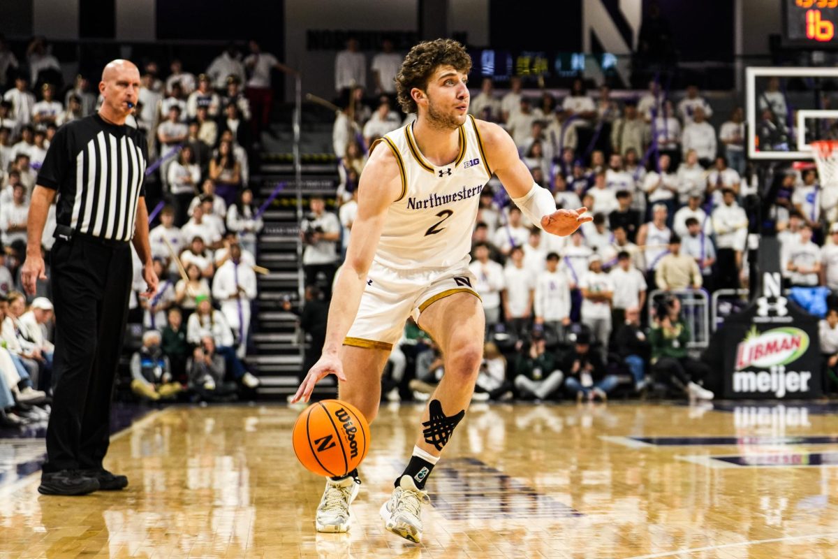 Junior forward Nick Martinelli dribbles the ball up the court in a game earlier this season. Martinelli had 17 points in Northwestern's loss to Illinois Sunday.