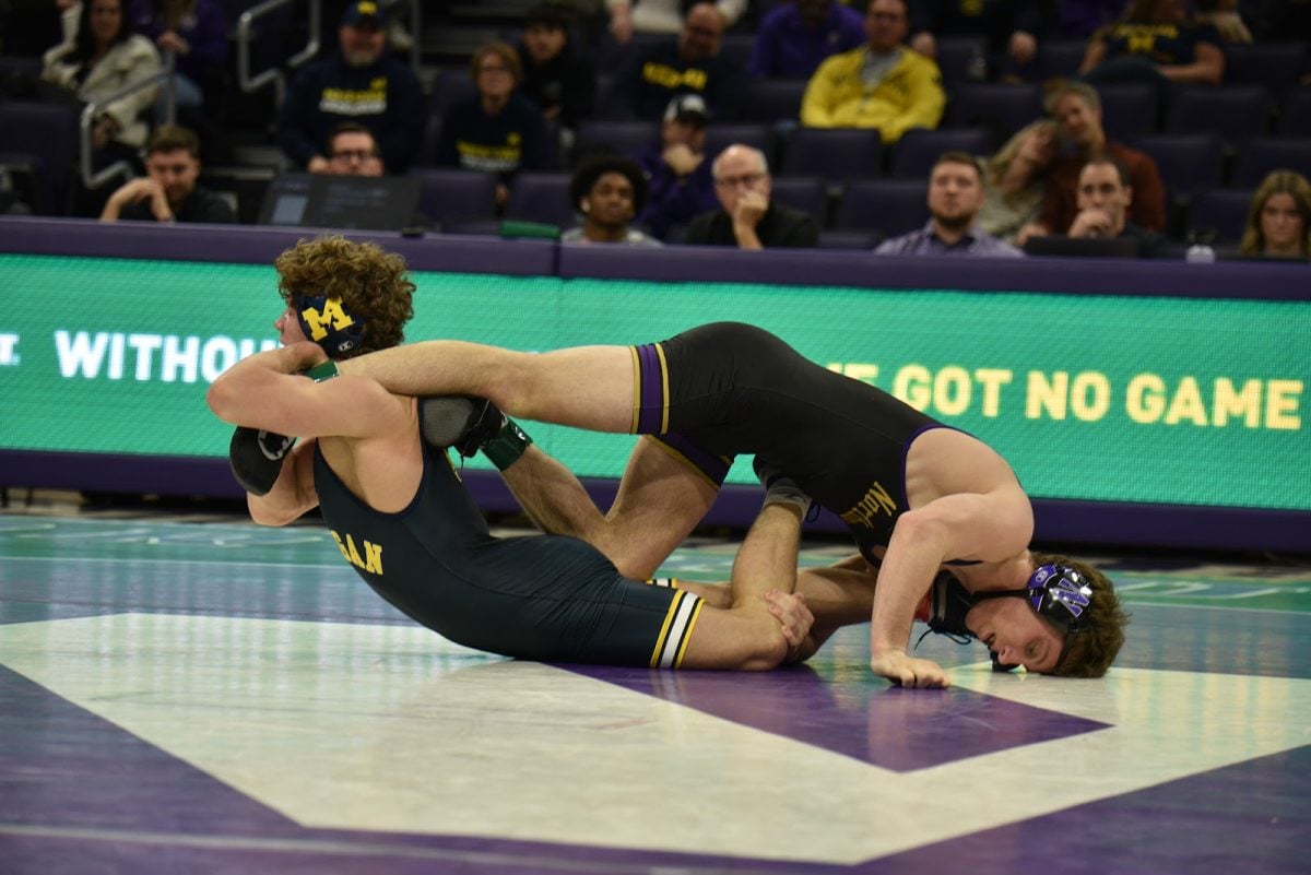 No. 23 redshirt freshman 149-pounder Sam Cartella and Michigan’s Dylan Gilcher are locked in a stalemate late in their overtime bout.