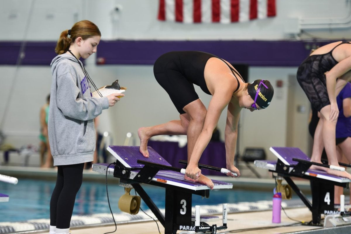 A Northwestern swimmer prepares to dive off the block during Saturday’s dual meet.  