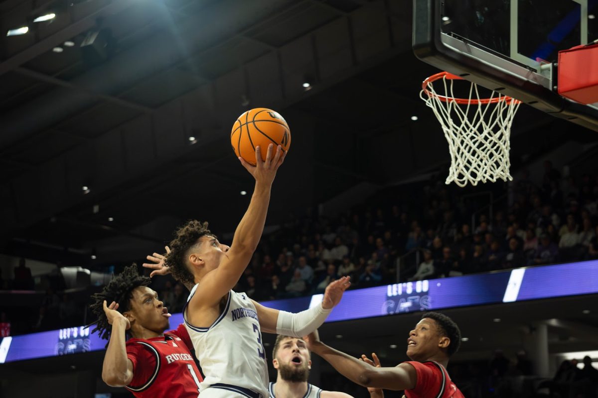 Graduate student guard Ty Berry shoots a layup in Northwestern’s loss to Rutgers Wednesday. 