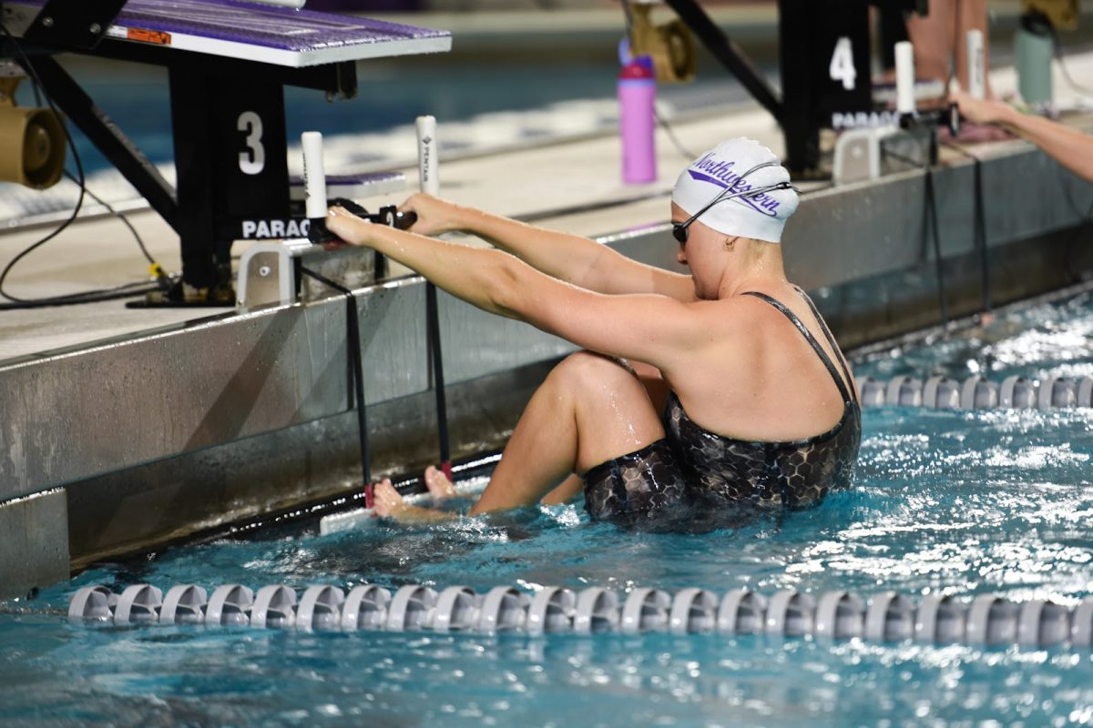 A Northwestern swimmer prepares to compete in the backstroke during a meet earlier this season. 