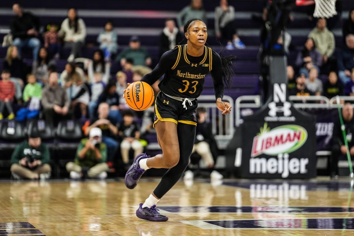 Graduate student forward Taylor Williams dribbles the ball up the court in a game earlier this year. 