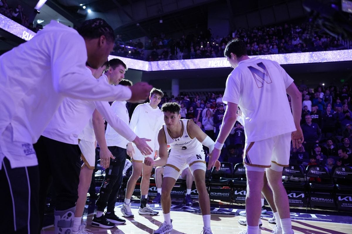 Graduate student guard Ty Berry high fives teammates ahead of a home game earlier this season.