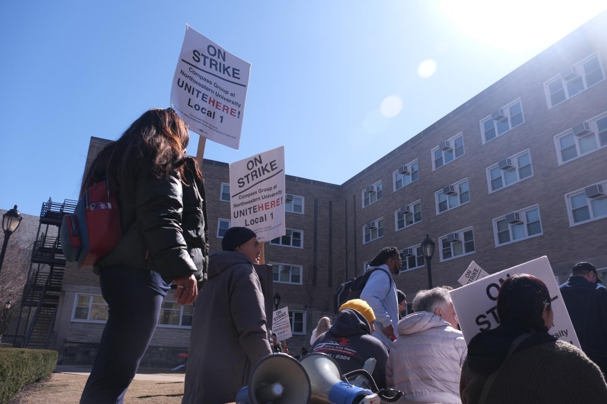 A group of dining hall workers on strike, students and other community members gathered in front of Allison Hall to listen to speeches.