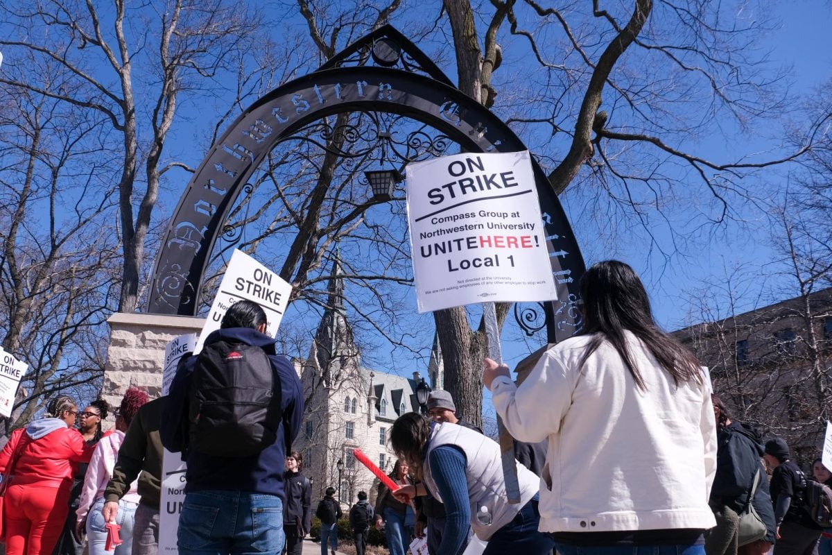 Strikers gathered at The Arch with picket signs and drums.