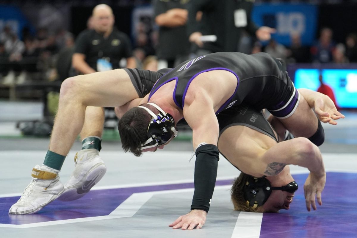 Graduate student 141-pounder Chris Cannon scrambles around Purdue’s Greyson Clark moments before a takedown.