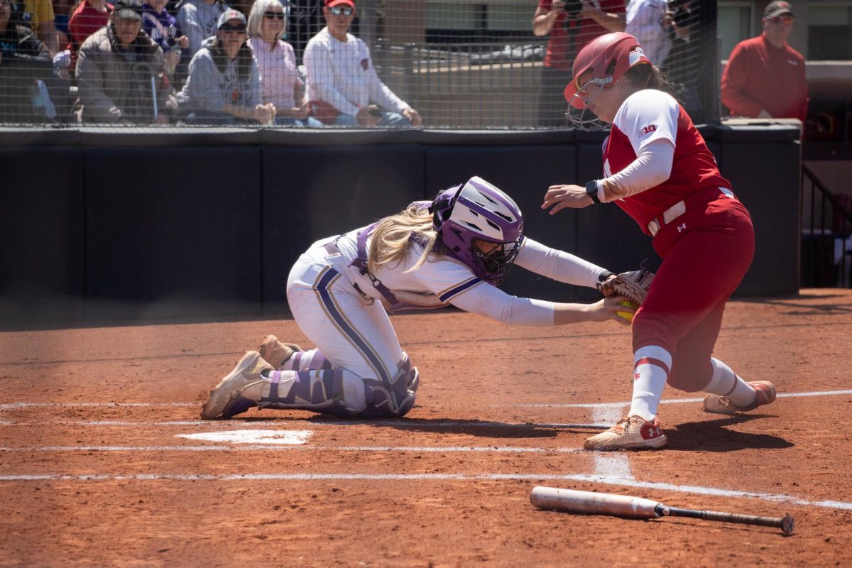 A player tags out a runner at home plate.