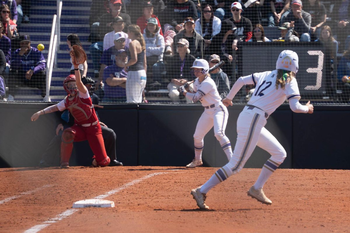 A player runs toward second base after a wild pitch.