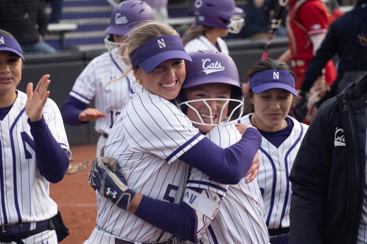 Two players embrace after a home run.