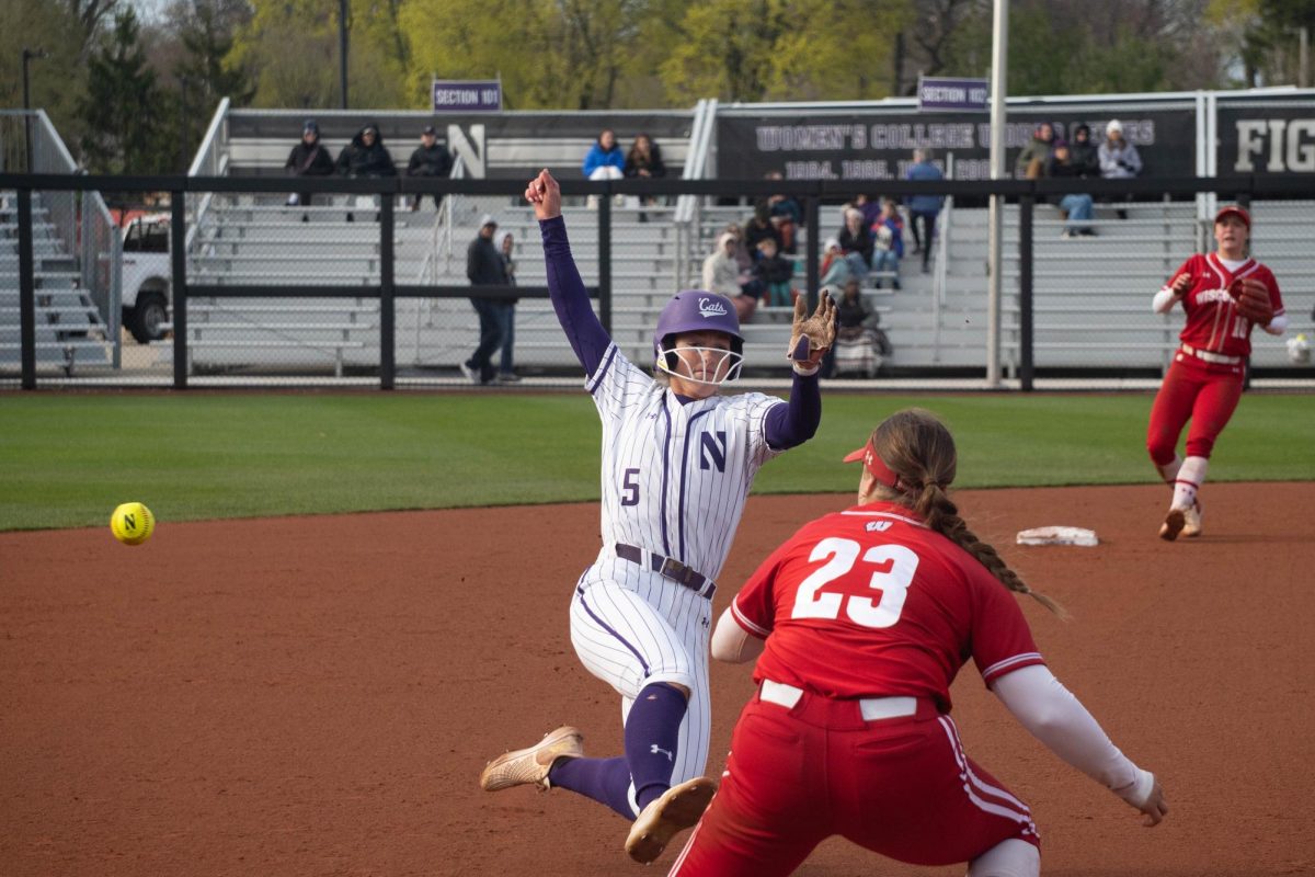 A player slides into third base as the throw comes in.
