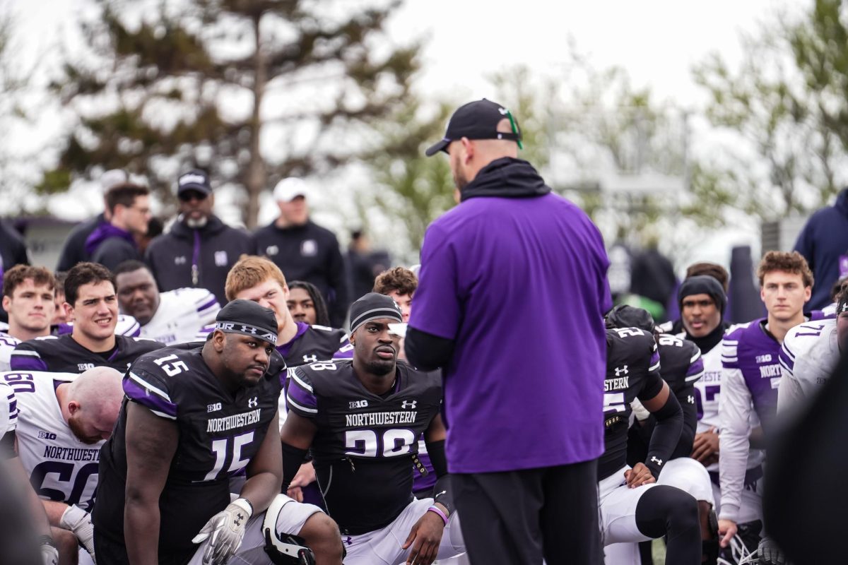 Coach David Braun speaks to his team after Northwestern’s Spring Practice. 