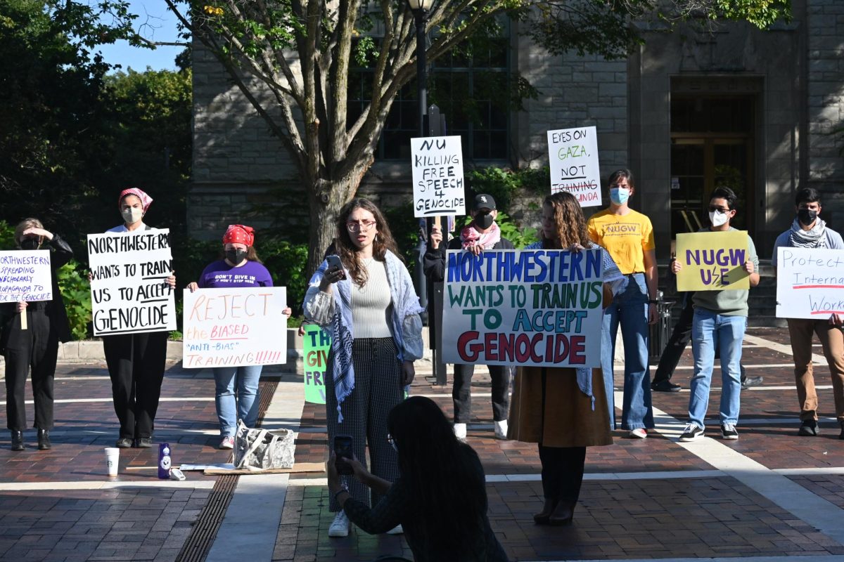 As people walked past, members of the protest took turns to speak out against the training with about a dozen people gathered to listen.