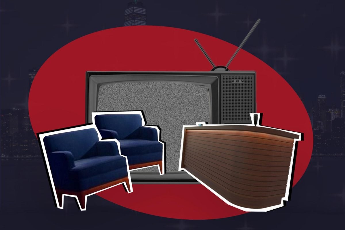 Two armchairs and a desk in front of a TV.