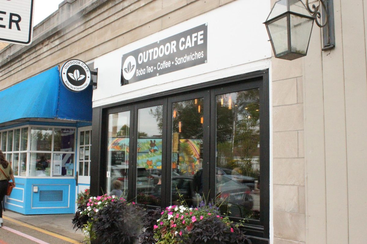 The front of a store with windows in the front and a sign above
