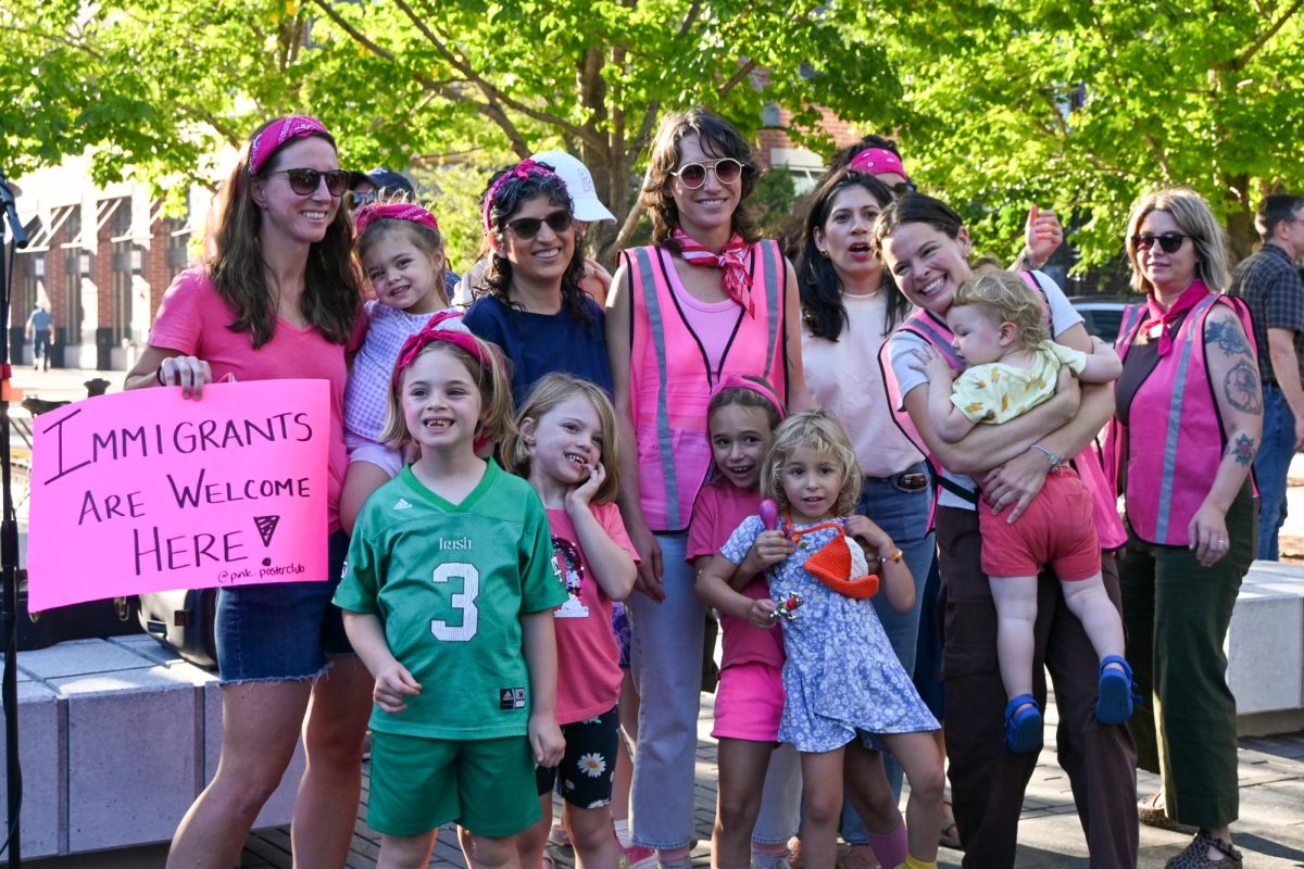 People wearing pink smile together.