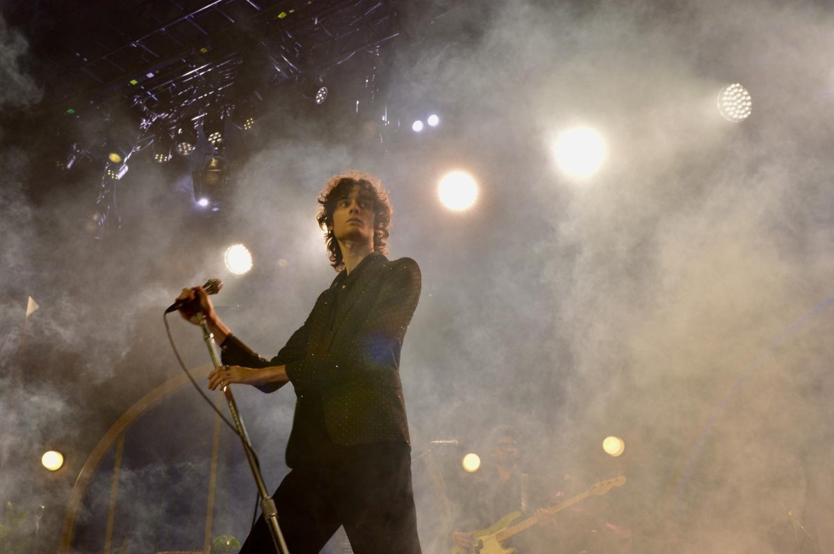 Singer seen from below with fog surrounding him. 