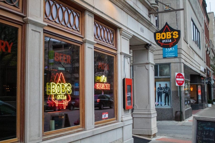 a storefront with the sign that says “Bob’s Pizza”