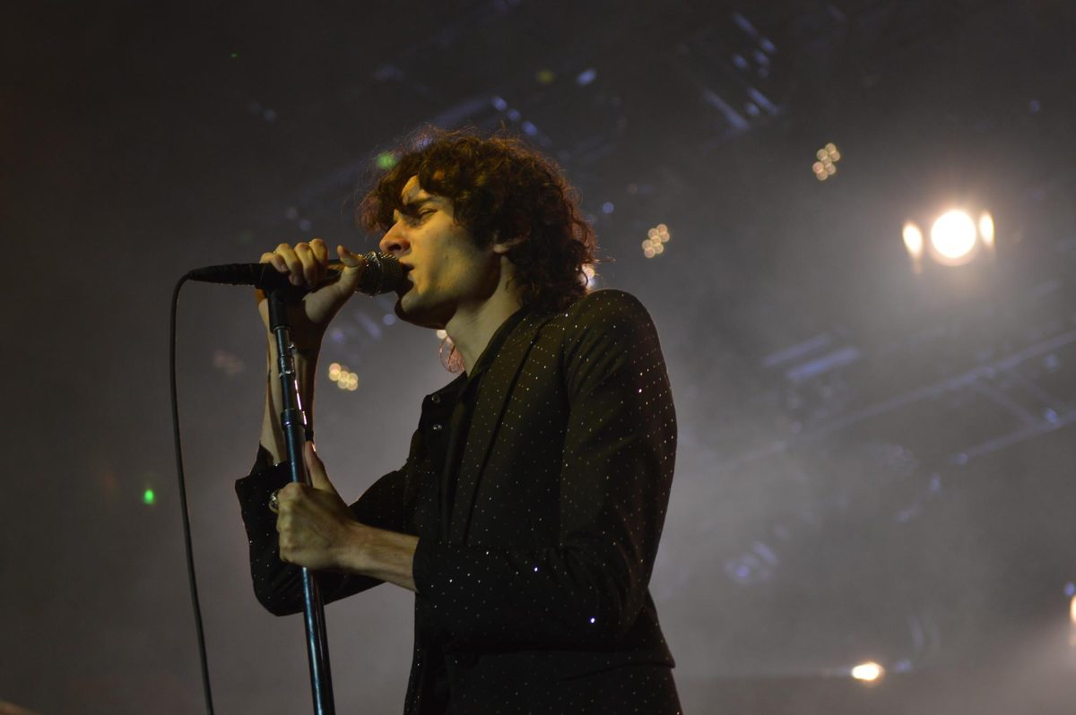Close-up of singer belting into microphone. 