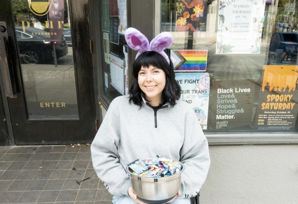 Gabi Cooney, Evanston Pour’s marketing manager, sits outside waiting to hand out candy to trick or treaters. 
