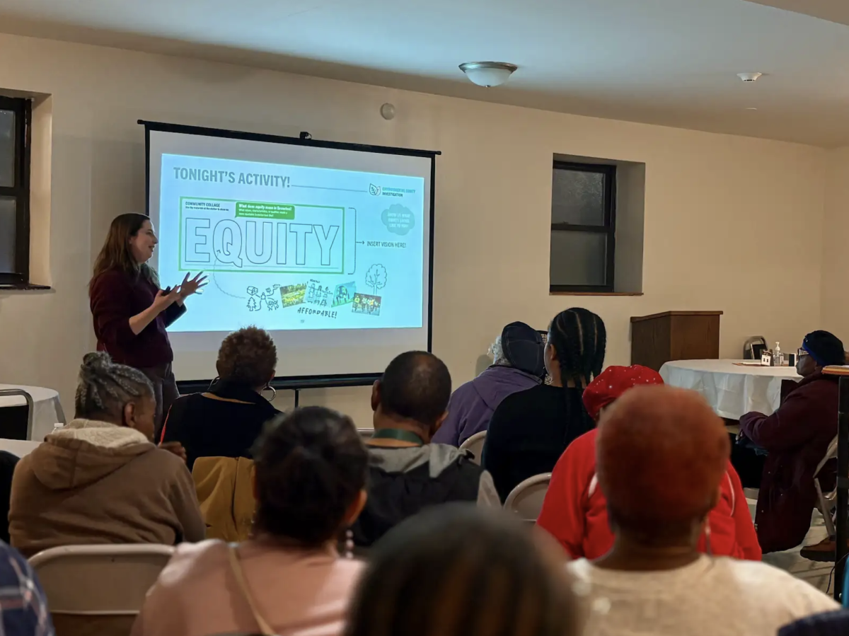 One person is giving a presentation on environmental equity in front of participants