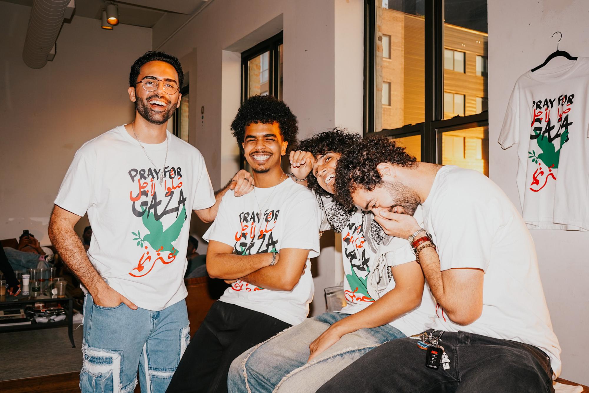 Four people smile at the camera and laugh together.