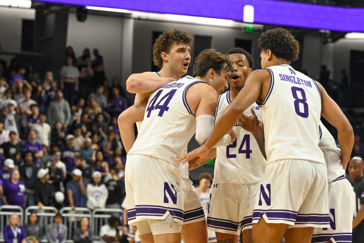 A group of basketball players huddle. 