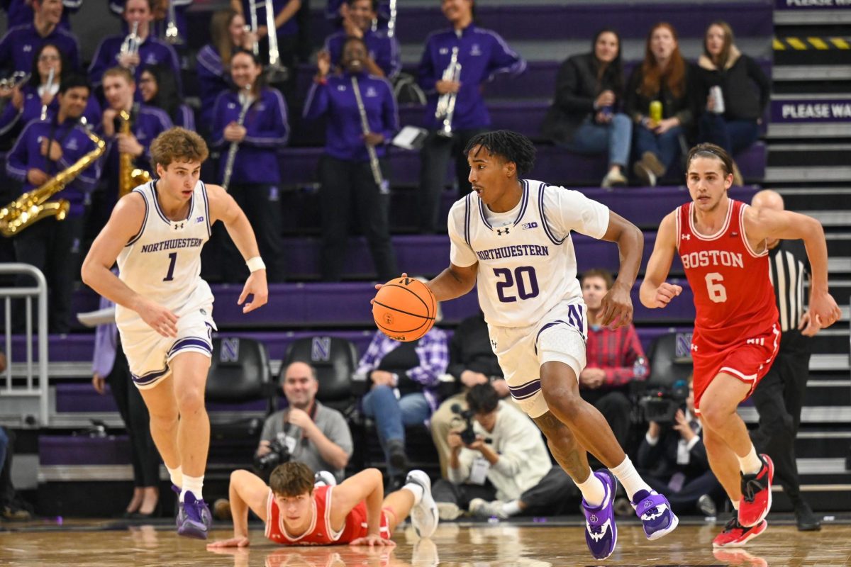 A basketball player dribbles up the court. 