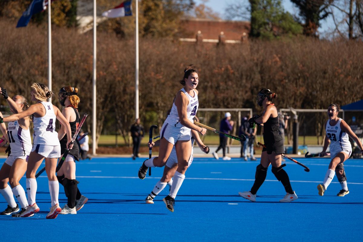 A player in a white jersey jumps in celebration. 
