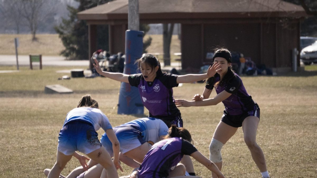 Northwestern players and UW Eau Claire players grapple for the ball.