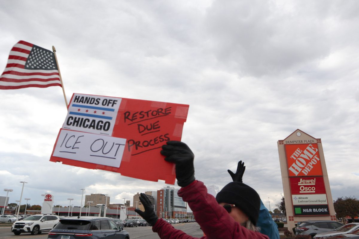 A woman holds a sign against ICE presence in Chicago.