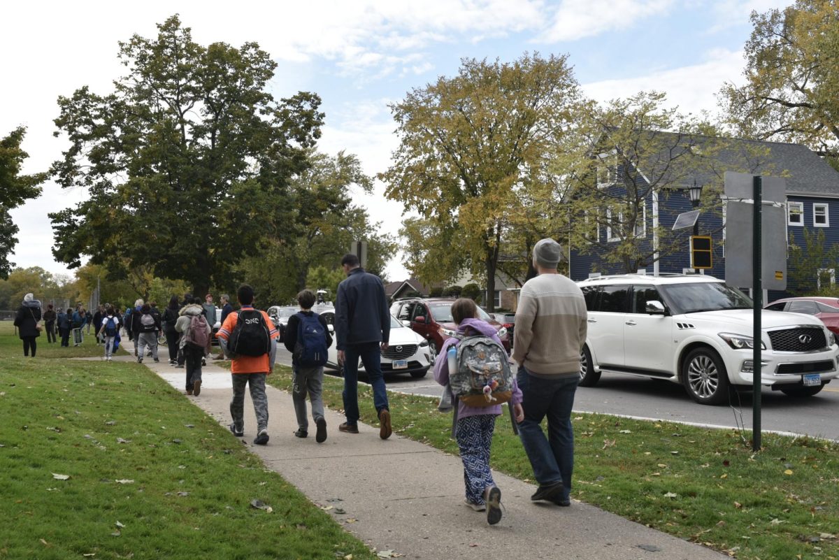 Children walk home with their parents outside Chute Middle School on Halloween.