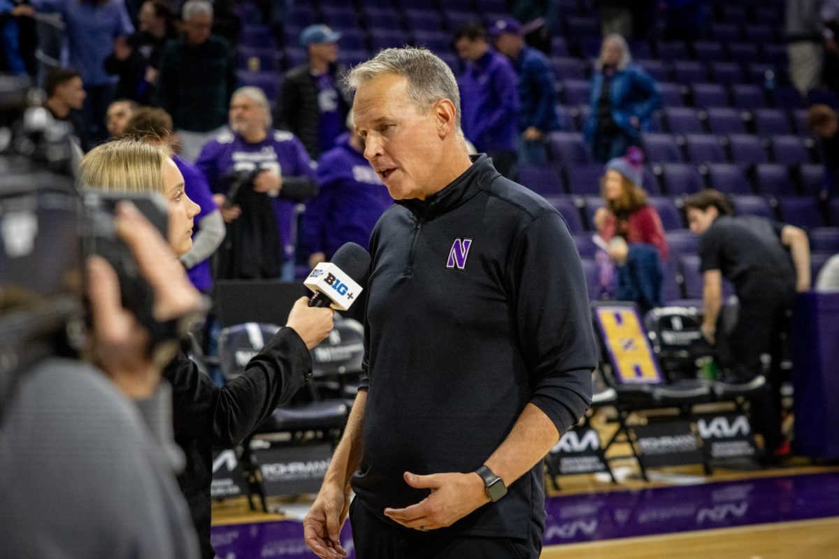 Northwestern men’s head basketball coach Chris Collins gets interviewed by a person working for B1G+.