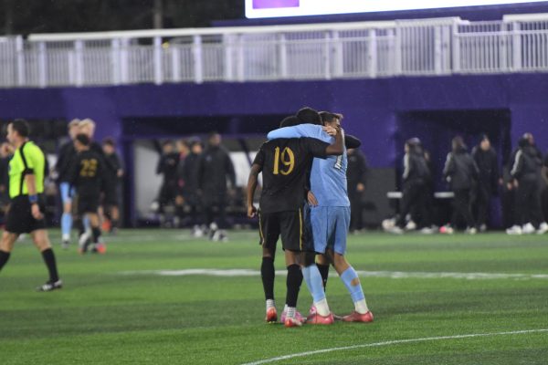Junior defender Fritz Volmar, senior goalkeeper Rafael Ponce de León and senior forward Alejandro Martinez Santamaria embrace after the full-time whistle.