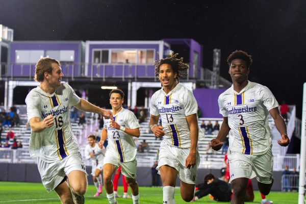 Freshman forward Aaron O'Reilly, junior midfielder Baraka Tarleton and freshman defender Andrew Johnson celebrate after Johnson equalized for NU.