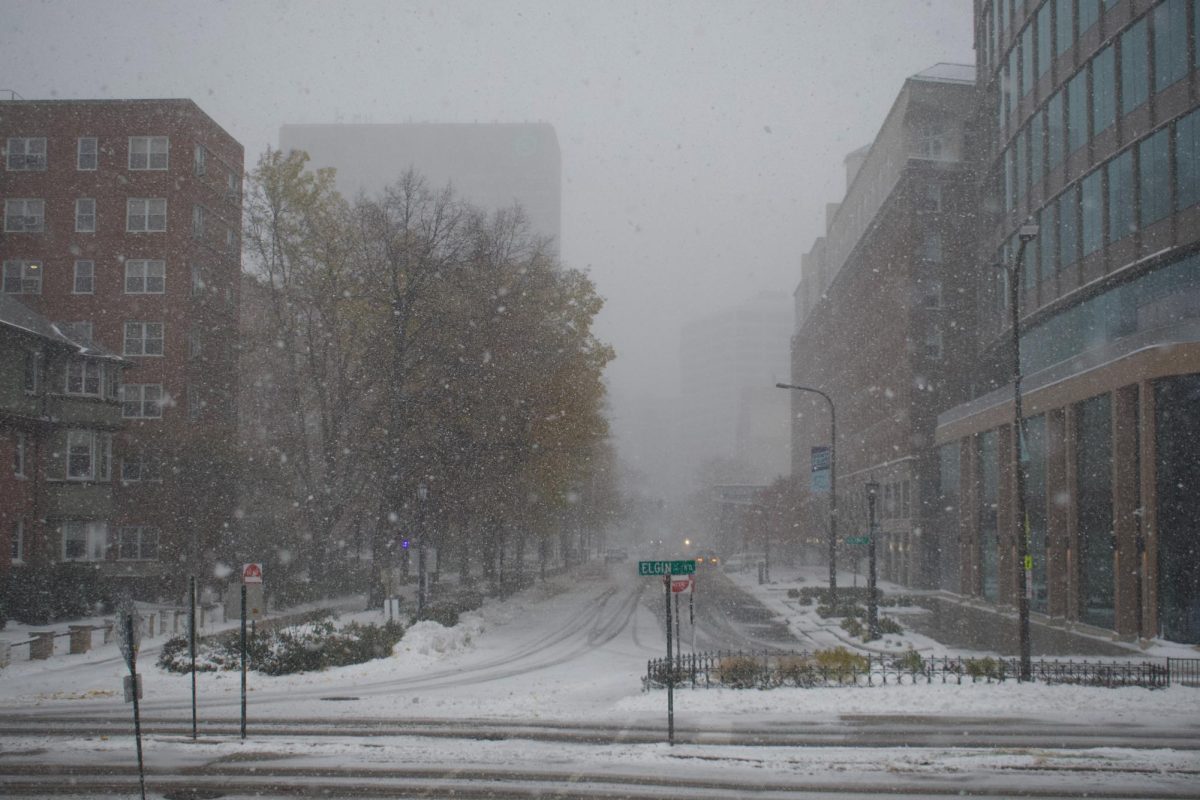 A snowy street with a street sign reading “Elgin” in the middle.