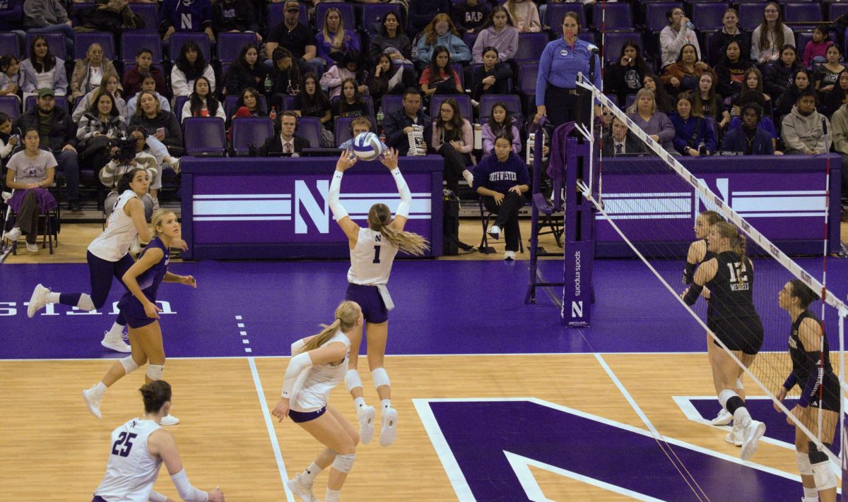 Sienna Noordermeer jumps to set the ball as a teammate gets ready to strike.