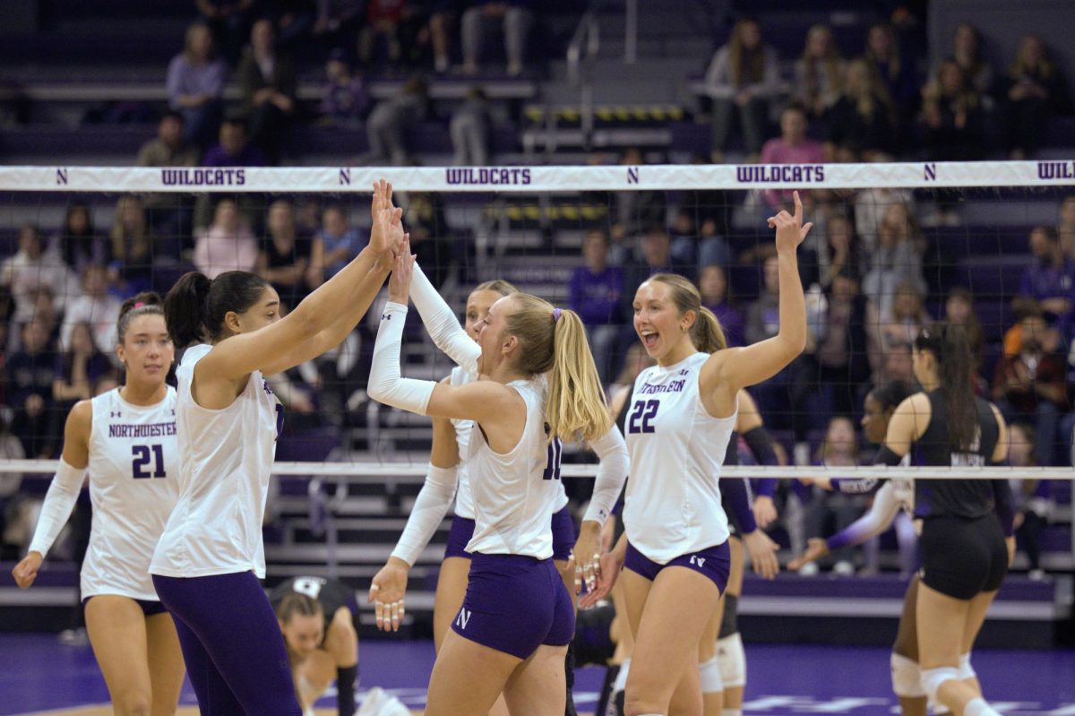 Northwestern players smile, cheer and high-five after winning a point.