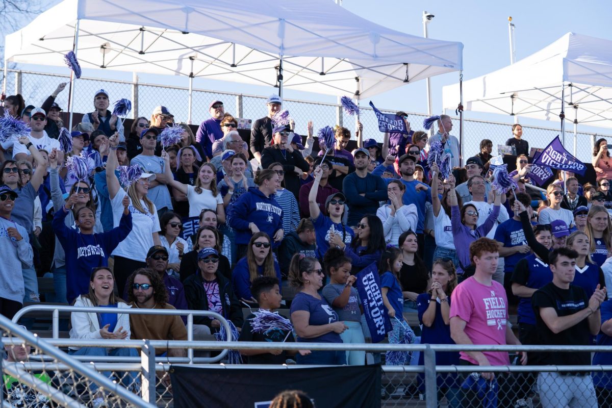 People in purple gear cheer. 