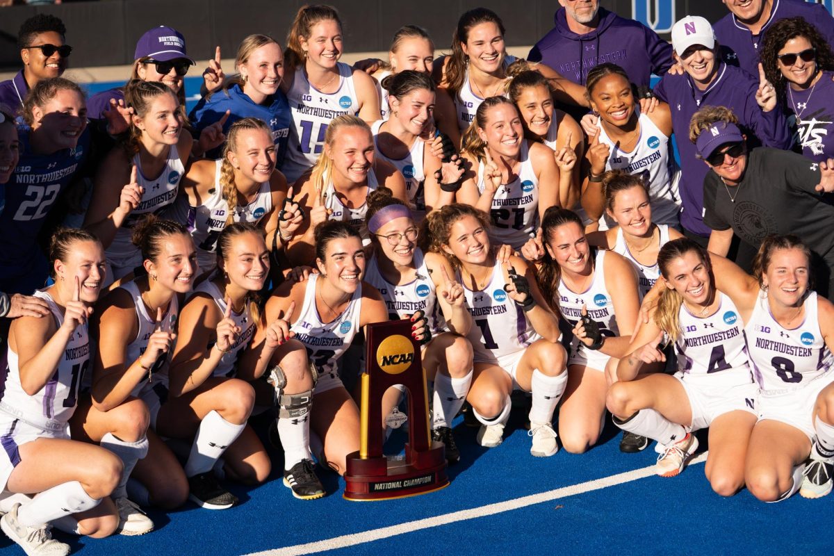 Players in white shirts smile with a trophy.