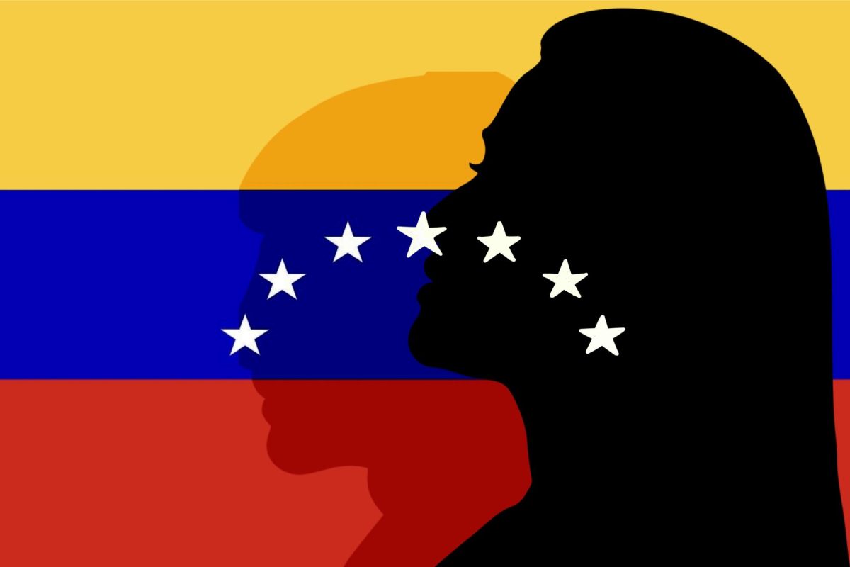 The silhouettes of two people against a yellow, blue and red flag.