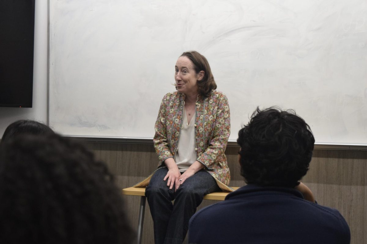 A woman talks in front of students.