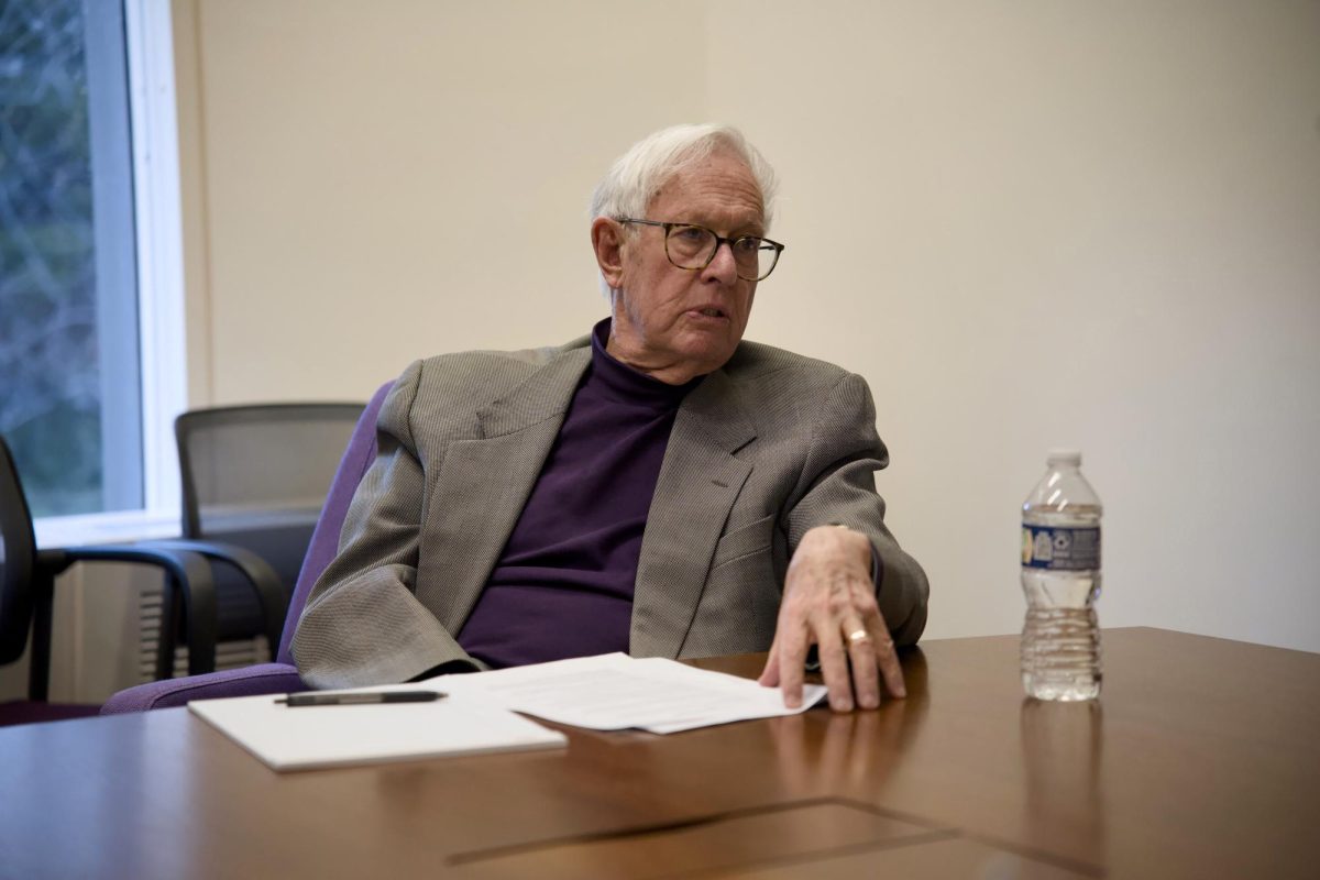 A man talks with his hand on the table.