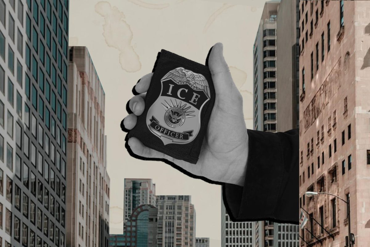A hand holding a badge between buildings.