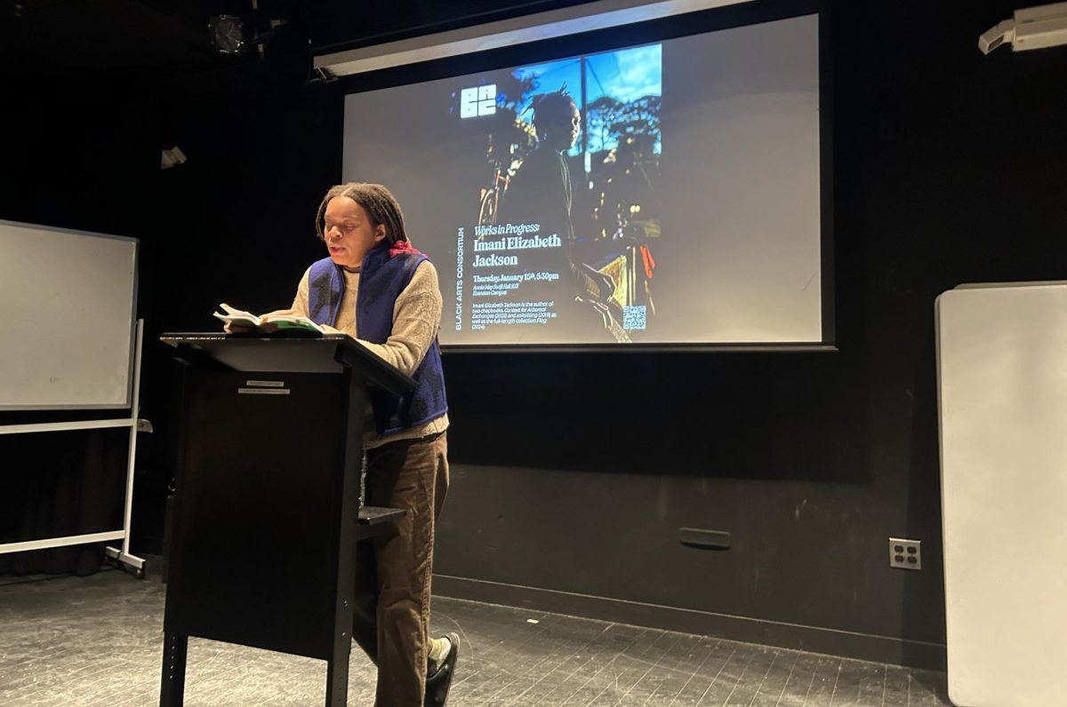 A woman reads from a stand.