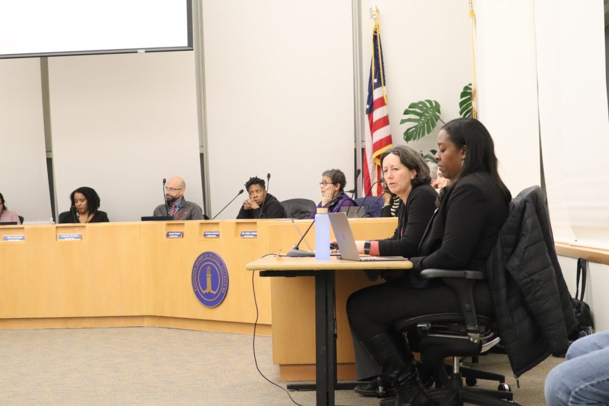 People sit behind a dais.