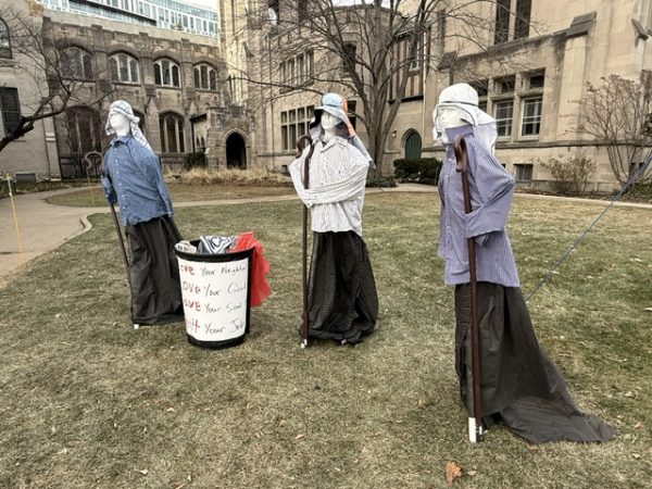 A Nativity scene alongside a trash can.