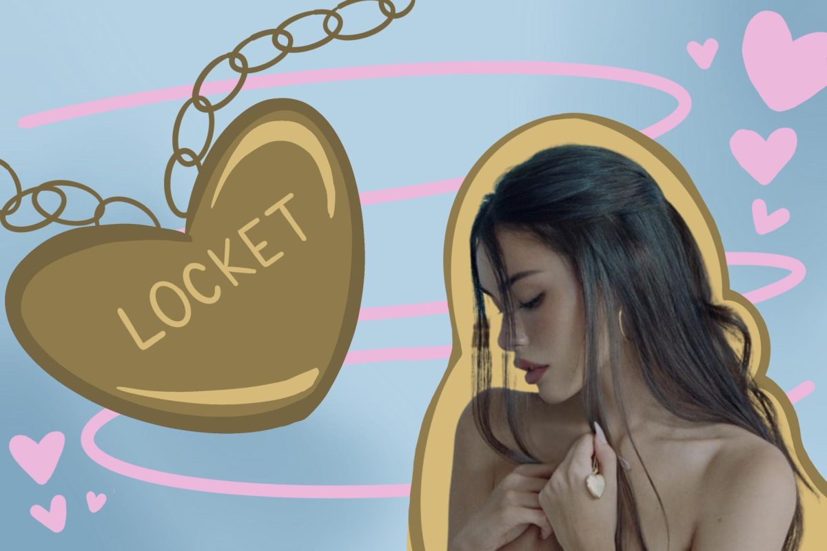 A person with black hair looks downward facing a beige heart displaying “LOCKET.”