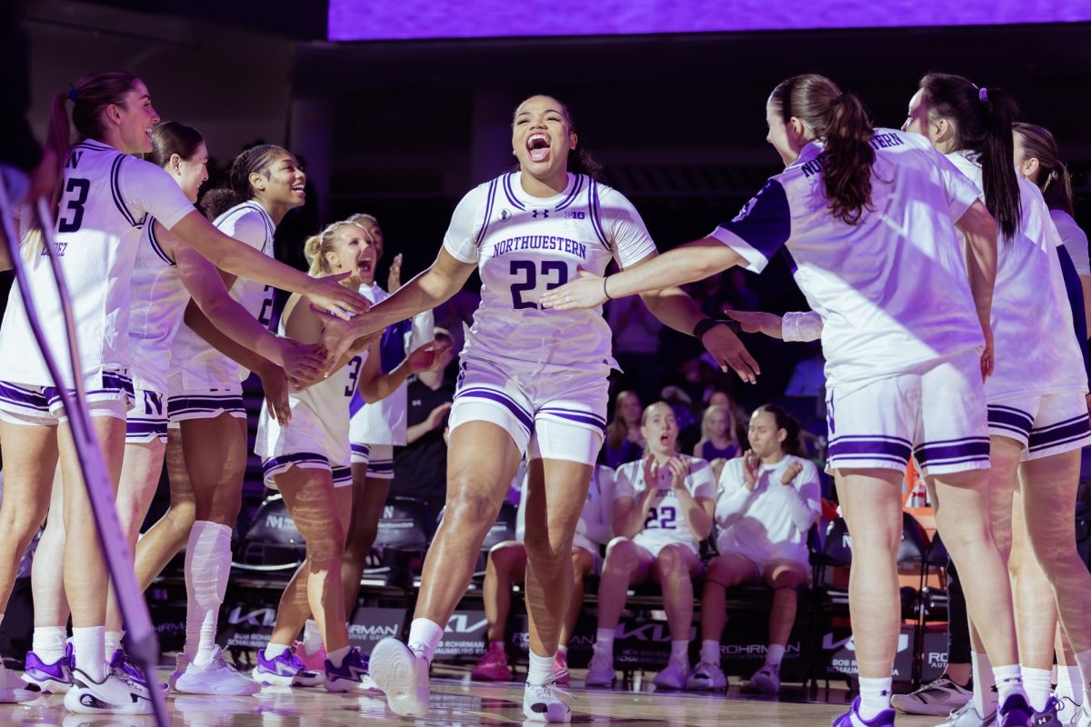 A Northwestern player runs through a tunnel of teammates in the pregame introductions.