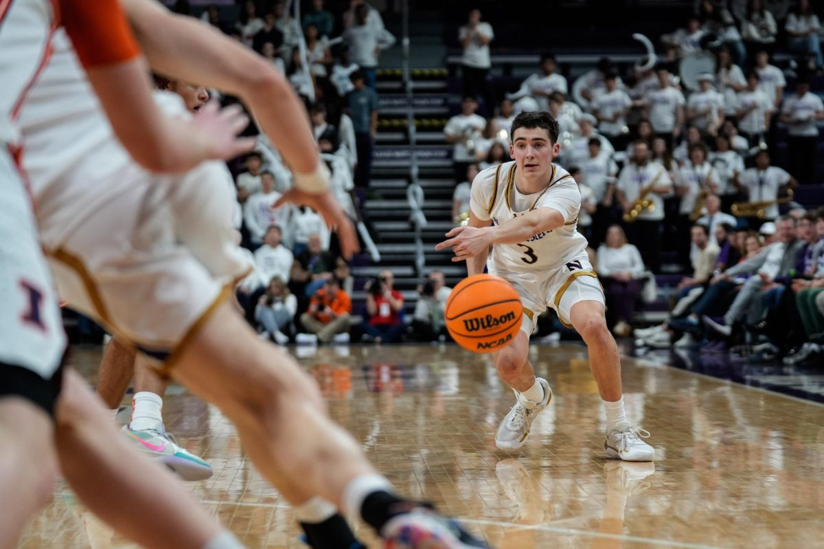 A basketball player bends their knees and stretches their arms out to pass the ball in front of them.
